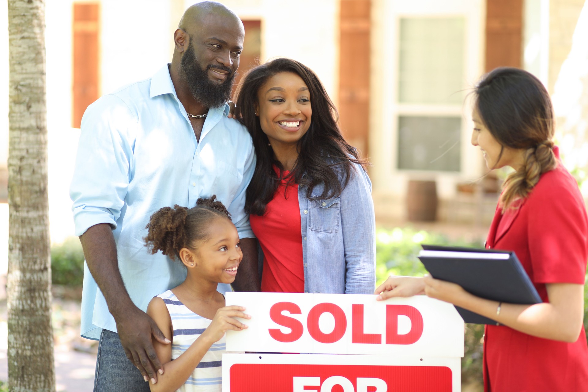 Real Estate Agent and family looking at new home to purchase.